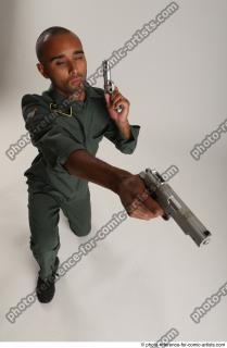 ERIC KNEELING POSE WITH GUNS